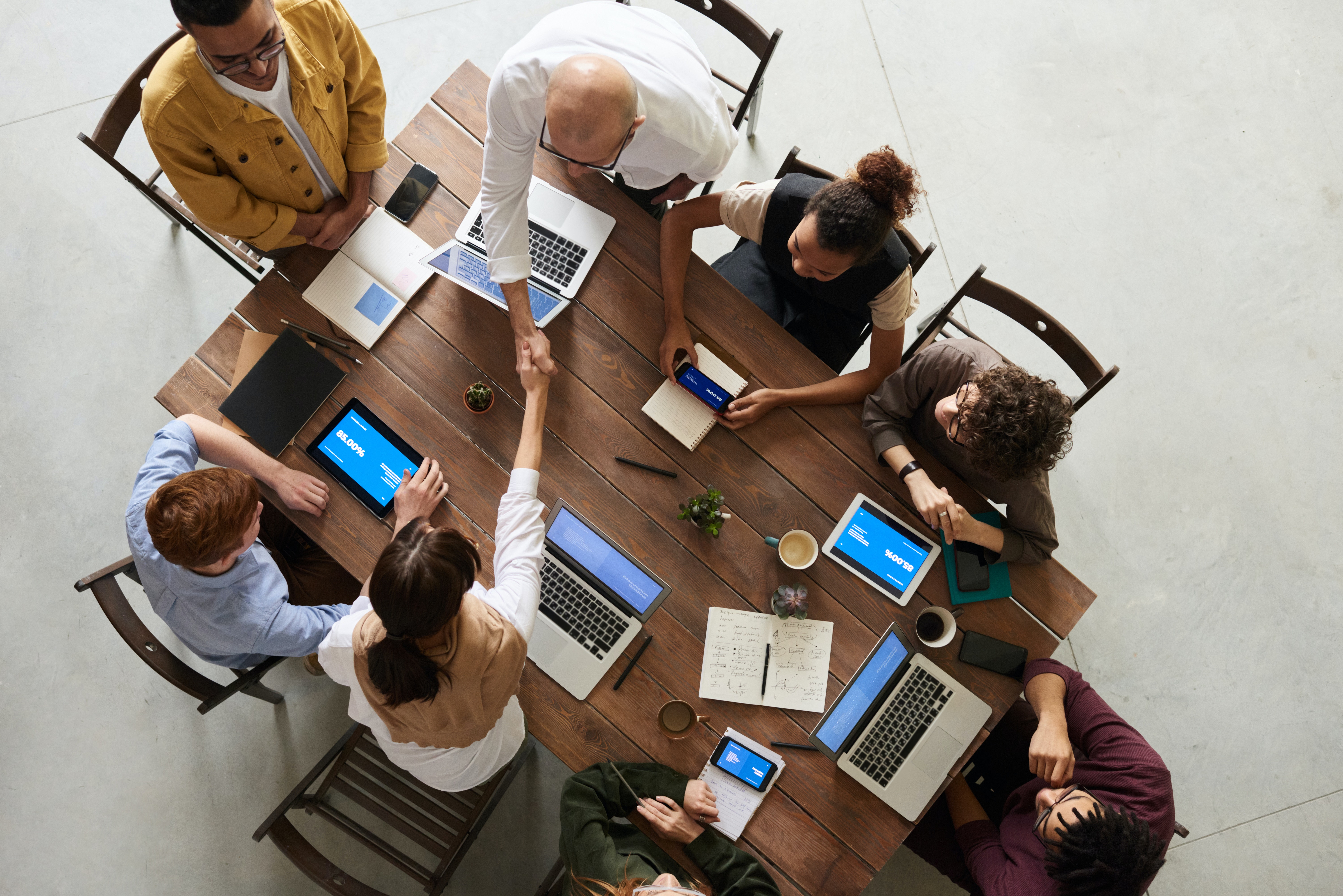 Featured image: Group of people working on laptops at a desk - Read full post: Marketing Primer for Market Researchers